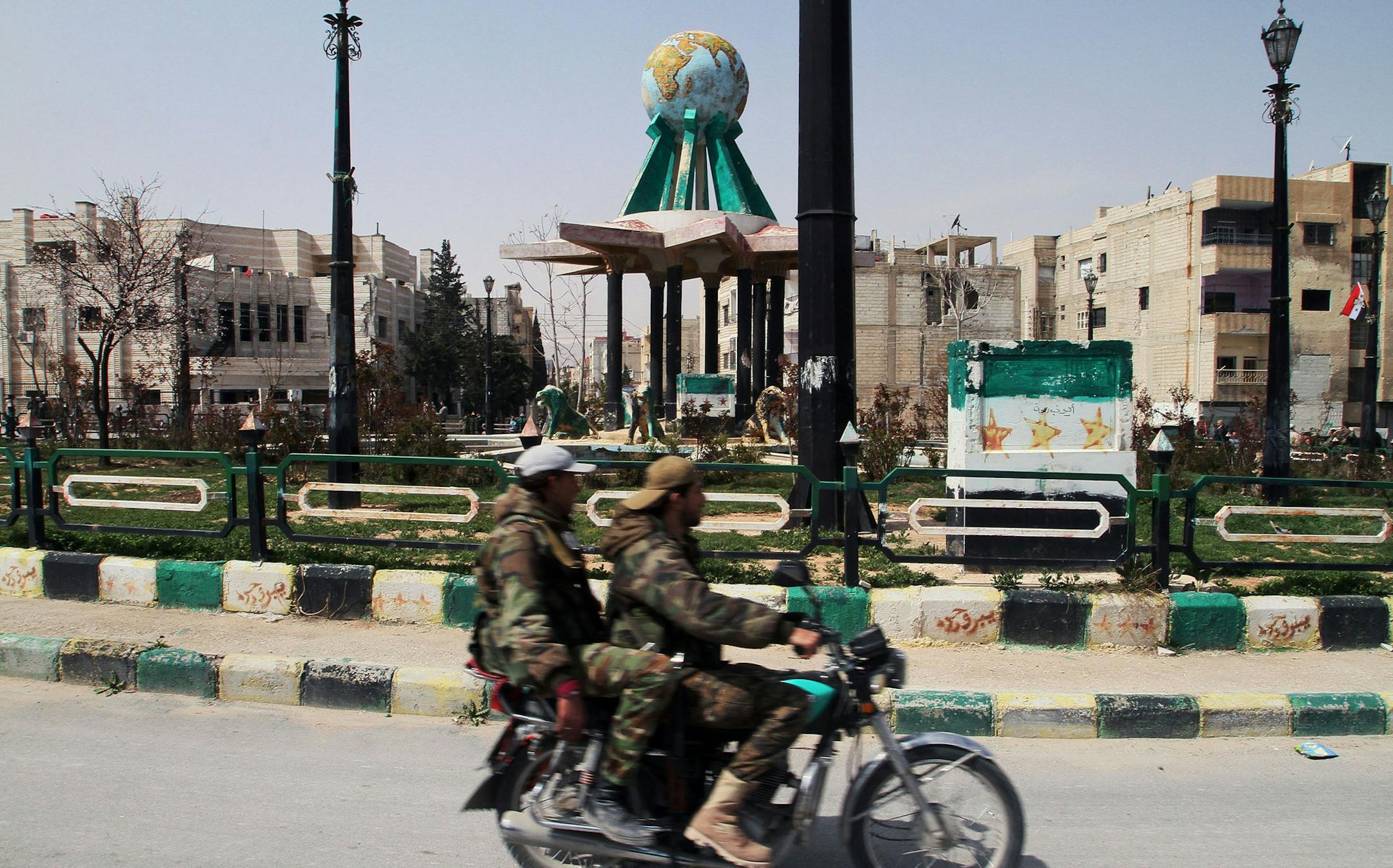 Syrian government forces ride a motorcycle around the main square after being deployed in Yabroud town, Syria, Sunday, March 16, 2014. Syrian troops backed by Hezbollah fighters seized a key rebel supply town on the Lebanese border on Sunday, driving them from the area and scoring a major blow against them in the three-year-old-conflict. The fall of Yabroud immediately emboldened government forces to attack nearby rebel-held towns, pressing forward in what has been nearly a yearlong advance agai