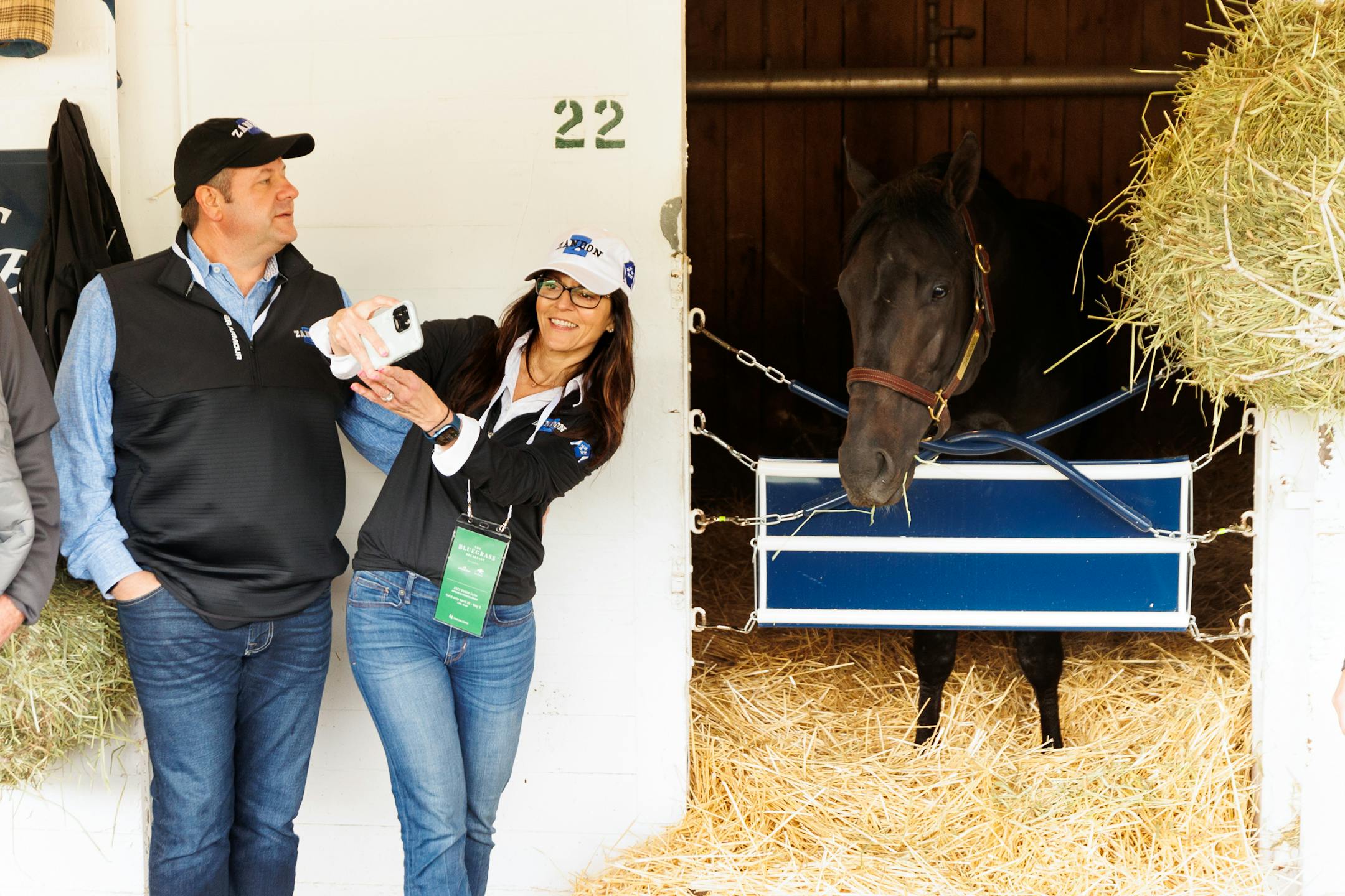 Jill Drown works to get a selfie with Zandon as her husband, Jeff, looks on at Churchill Downs.