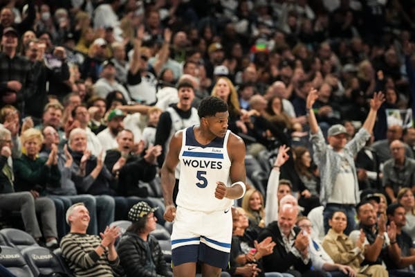 Minnesota Timberwolves guard Anthony Edwards runs downcourt to cheering fans after making a three point shot in the second half.