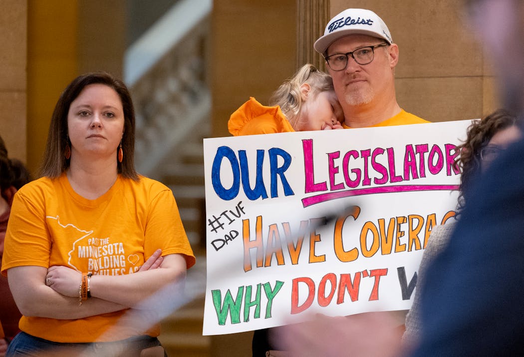 Miraya, Isla and Andy Gran join a rally at the Capitol in St. Paul calling for Minnesota to require insurers to cover IVF.
