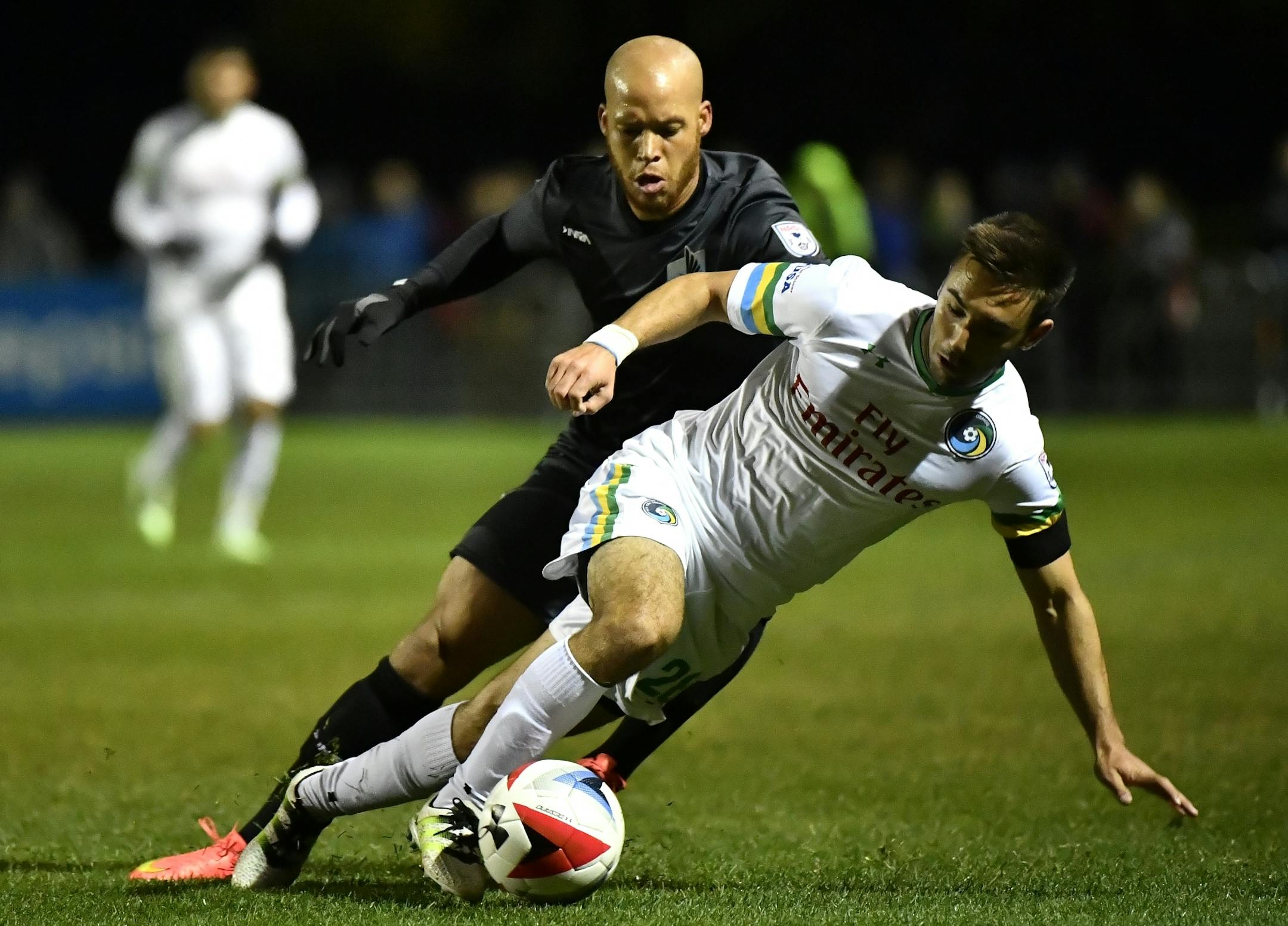 Minnesota United FC forward J.C. Banks (29) and New York Cosmos defender Jimmy Mulligan (28) battled for the ball in the first half.