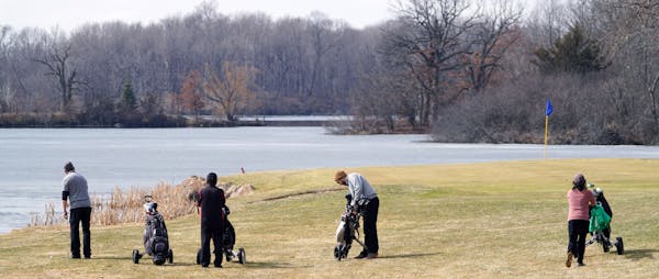 Golfers hit Stonebrooke Golf Club in Shakopee Thursday. The course was open with guidelines on how to stay in compliance with social distancing, but i