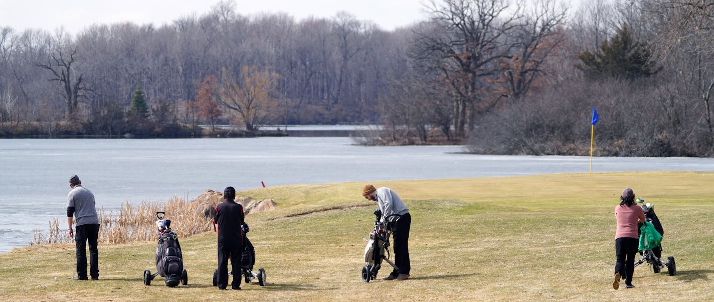 Golfers hit Stonebrooke Golf Club in Shakopee Thursday. The course was open with guidelines on how to stay in compliance with social distancing, but it is set to close after Gov. Tim Walz's stay-at-home order goes in effect Friday night. Golf courses are also lobbying to get some relief after Walz's new ruling.