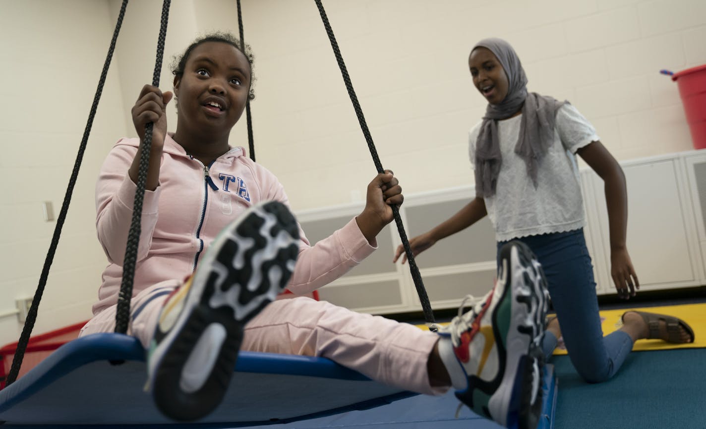 Peer Insights student Muna Mohamed-Karie, 13, right, gave Hanan Sharif a push on a swing during the school day at South View Middle School in Edina, Minn., on Tuesday, September 24, 2019. ] RENEE JONES SCHNEIDER &#xa5; renee.jones@startribune.com At Edina's South View Middle School, a program called Peer Insights pairs special education students with their general education peers -- and is making a big difference across the school. The program, started a few years ago by a special education teac