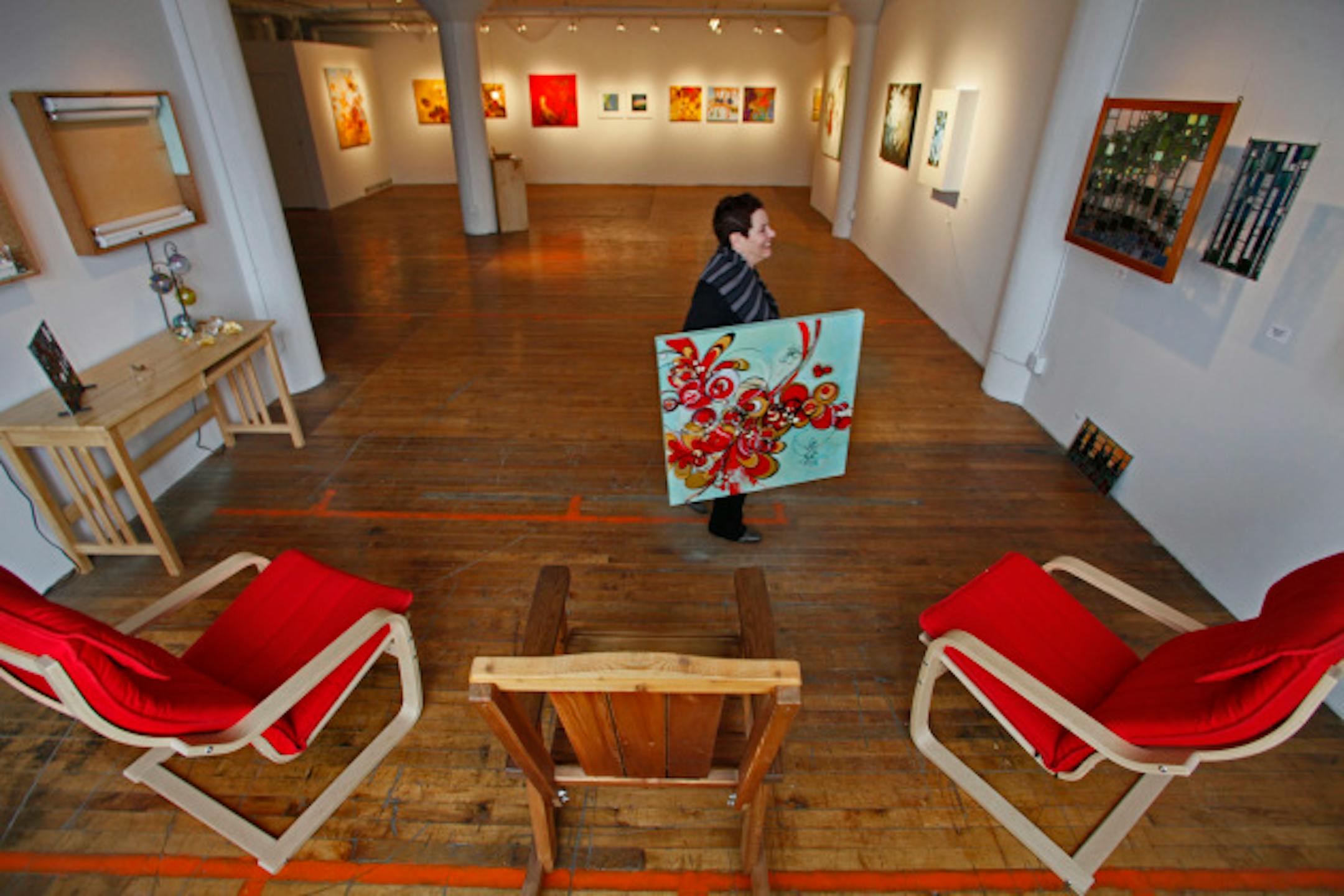 MARLIN LEVISON*mlevison@startribune. A look at the Northrup King Building in NE Minneapolis with its various galleries, including Kolman Galler, Danish Teak Classics and Gallery Co. THIS PHOTO:  ]Anita Sue Kolman in the Kolman Gallery carrying a painting by Patrick Kemal Pryor.