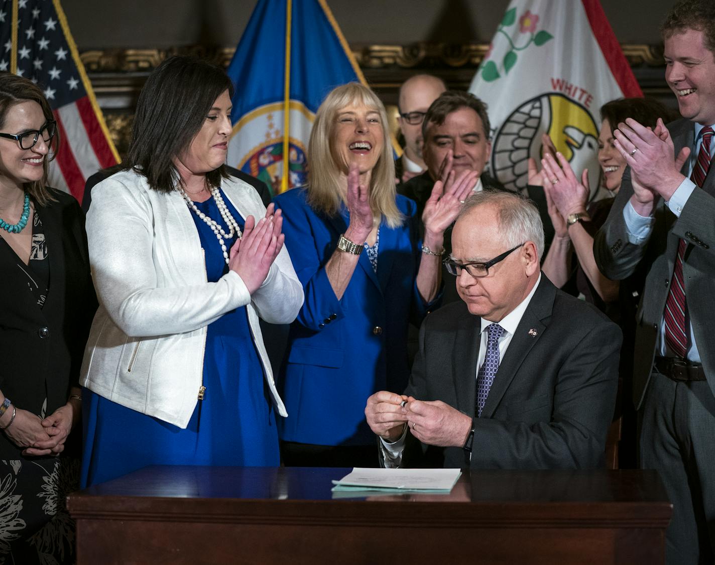 Gov. Tim Walz receives applause after signing into law a repeal of the state's pre-existing relationship defense. From left is Lt. Gov. Peggy Flanagan and Jenny Teeson. ] LEILA NAVIDI &#xa5; leila.navidi@startribune.com BACKGROUND INFORMATION: Gov. Tim Walz signs into law a repeal of the state's pre-existing relationship defense at the Capitol in St. Paul on Thursday, May 2, 2019. The law was championed through the legislative process by Jenny Teeson, who survived years of sexual assault by her