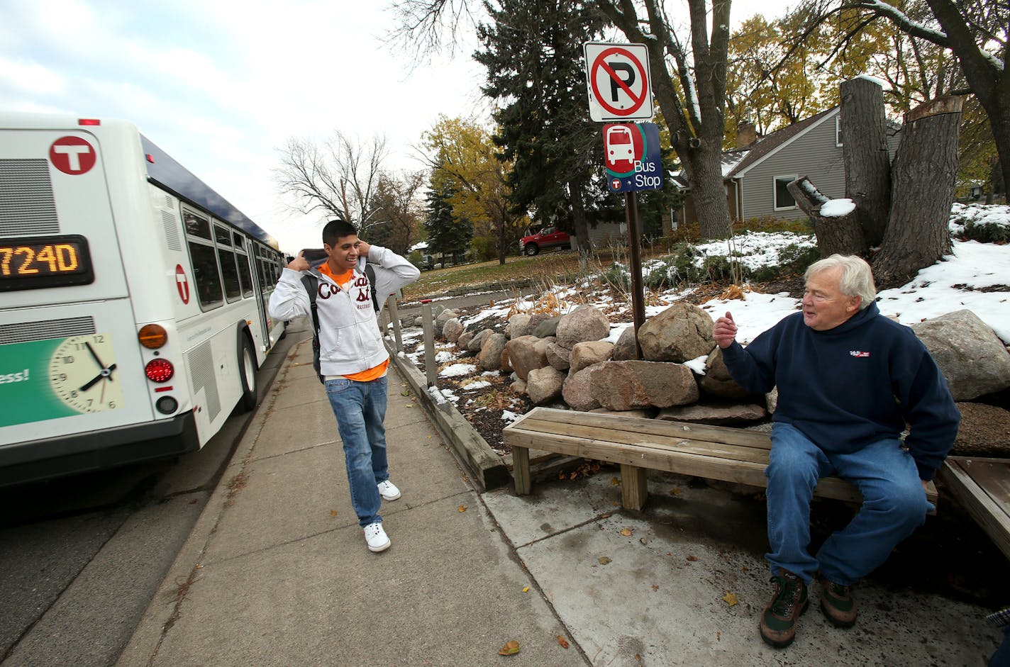 Jerry Evans talks with high school student Jovany Negrete at the bus stop. Jerry Evans was honored the city's act of kindness award after he built his own bus stop on his front lawn on Brooklyn Blvd. in Brooklyn Center, MN. November 7, 2013. ] JOELKOYAMA&#x201a;&#xc4;&#xa2;joel koyama@startribune It just seemed dangerous to Jerry Evans. Families with children waiting for the city bus on the thin strip of sidewalk in front of his home on busy Brooklyn Blvd. Kids fidgeted and waited just inches fr