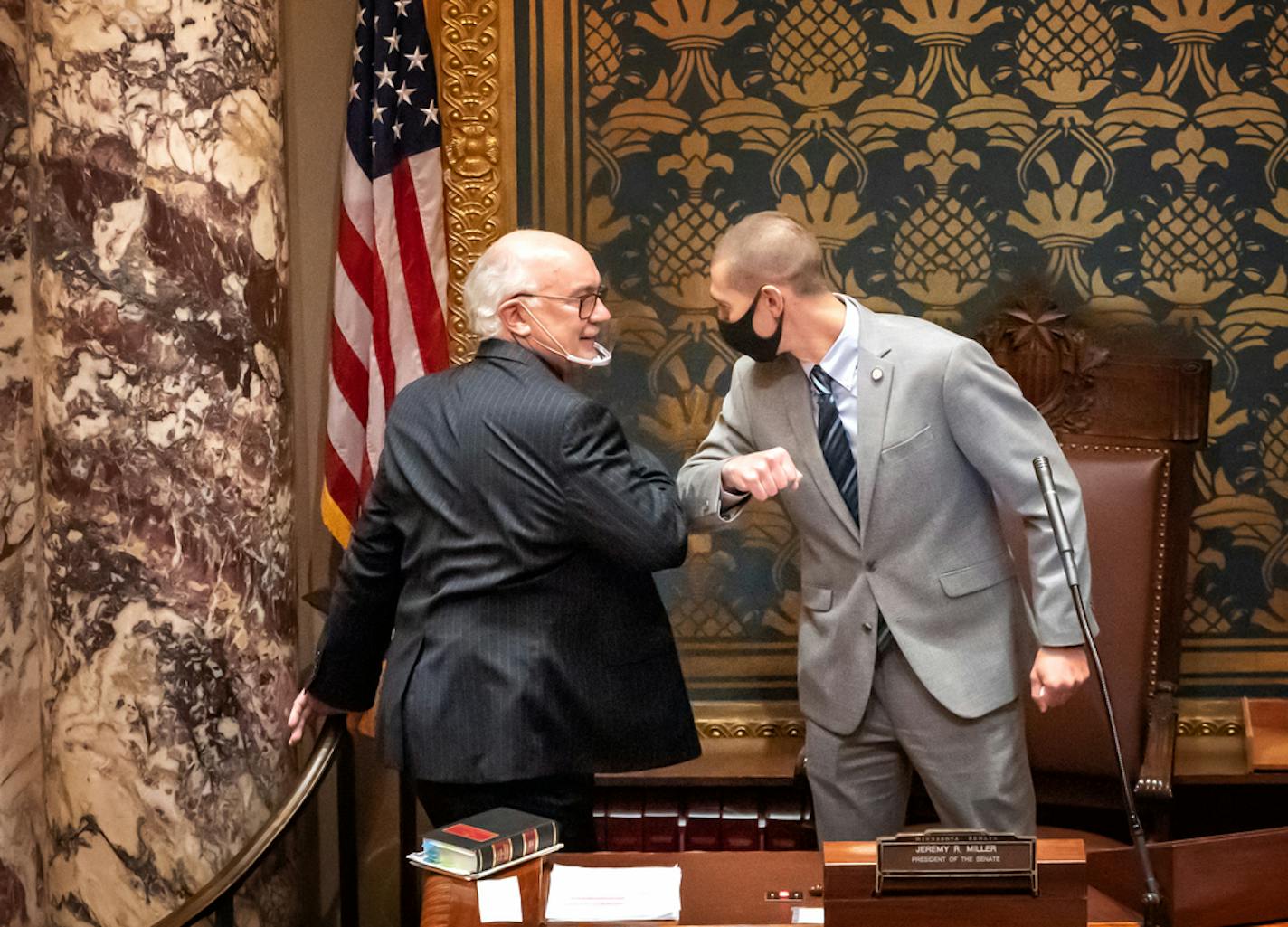 Outgoing Senate President Senate President Jeremy Miller, R-Winona, right, gave Sen. David Tomassoni, DFL-Chisholm, a congratulatory elbow bump before Tomassoni addressed the Senate Chamber.