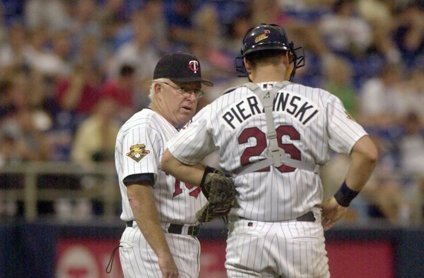 SUNDAY_08/05/01_Mpls. - - - - - Twins manager Tom Kelly talked with catcher A.J.Pierzynski as pitcher #32 LaTroy Hawkins (not in frame) prepared to take the mound.