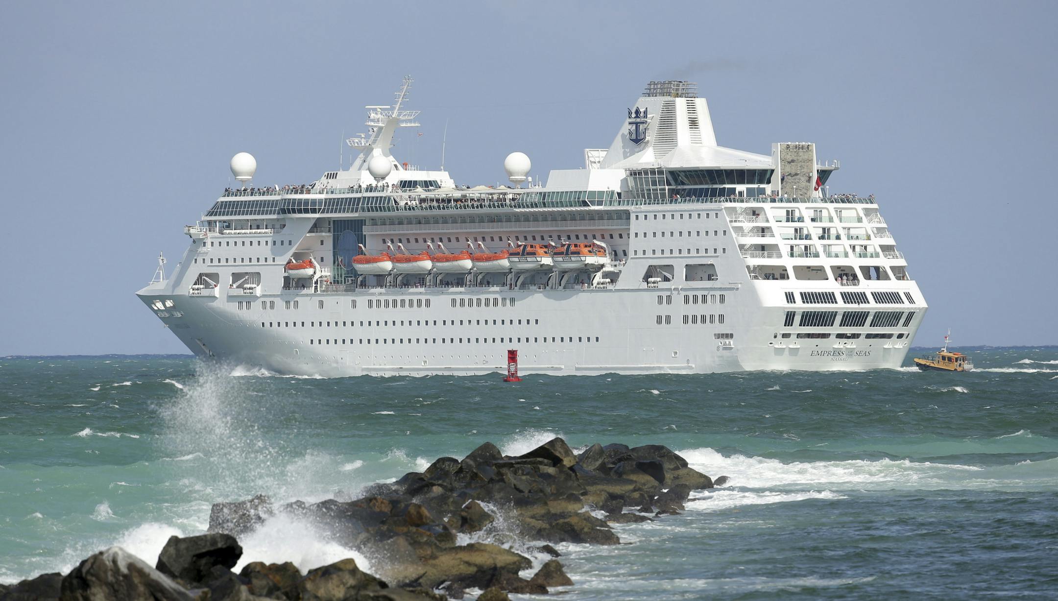 FILE - In this June 20, 2016 file photo, the Royal Caribbean cruise ship Empress of the Seas heads out of PortMiami, in Miami Beach, Fla. Royal Caribbean says it's now canceled eight cruises out of China through March 4, 2020 and is enacting measures to keep guests and crew safe from the virus outbreak that began in China. The number of cruise cancellations is increasing, as Royal Caribbean had announced last week that it was cancelling three cruises through Feb. 8. (AP Photo/Lynne Sladky, File)