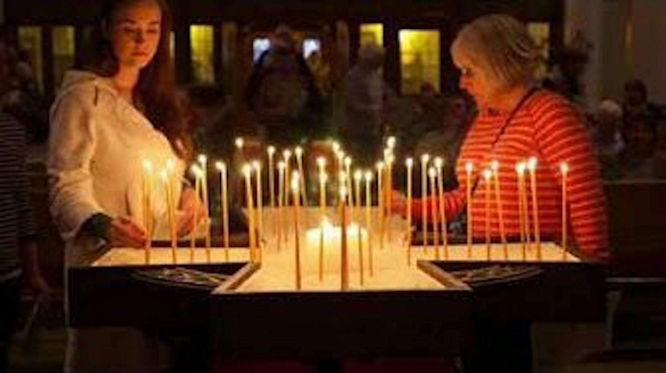 Women light and place candles at the Celtic contemplative evening service at Pilgrim Lutheran Church in St. Paul. Photo by Chuck Regal, Pilgrim Lutheran Church.