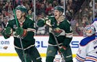 Matt Boldy (12) and Joel Eriksson Ek of the Minnesota Wild celebrate a goal in the first period Monday, December 12, 2022, at Xcel Energy Center in St