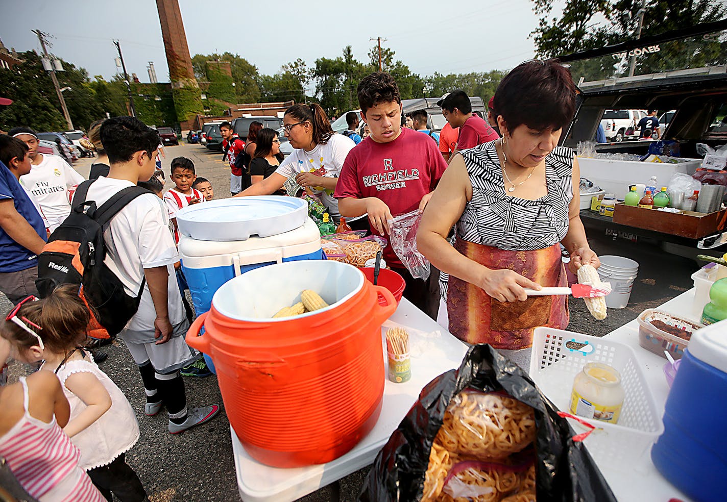 Veronica Vidal set up a concession stand with food that one would normally find in Mexico, such as corn on the cob, pork rinds with hot sauce, Mexican chips and Mexican candy, during a soccer tournament, Saturday, August 29, 2015 at Holy Angel High School in Richfield, MN. ] (ELIZABETH FLORES/STAR TRIBUNE) ELIZABETH FLORES &#x2022; eflores@startribune.com