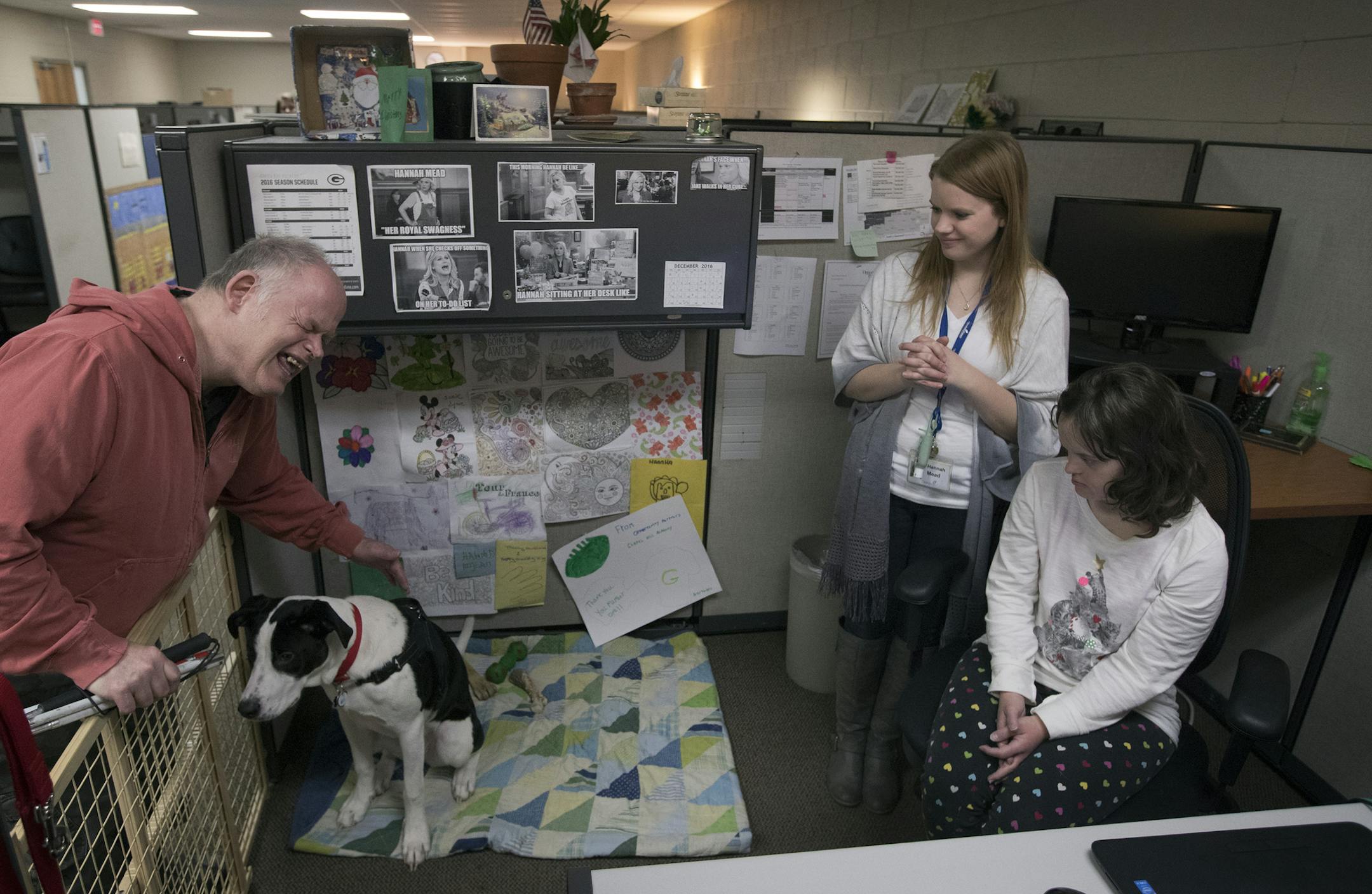 Robert Gregersen petted Nitro as owner Hannah Mead (standing) and Ashley Hardy looked on at Opportunity Partners in Minnetonka.