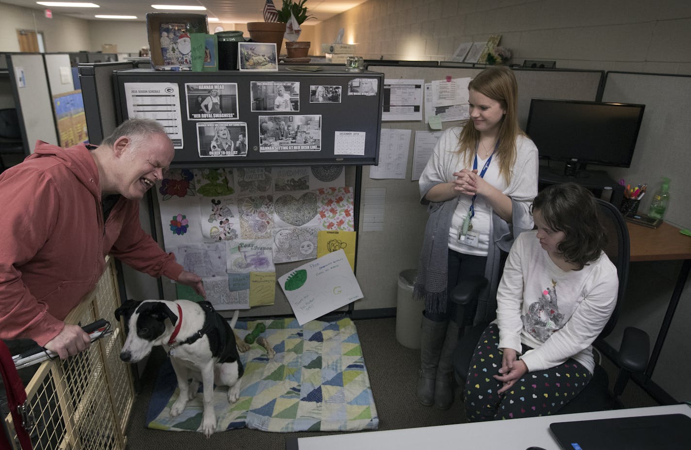 Robert Gregersen petted Nitro as owner Hannah Mead (standing) and Ashley Hardy looked on at Opportunity Partners in Minnetonka.