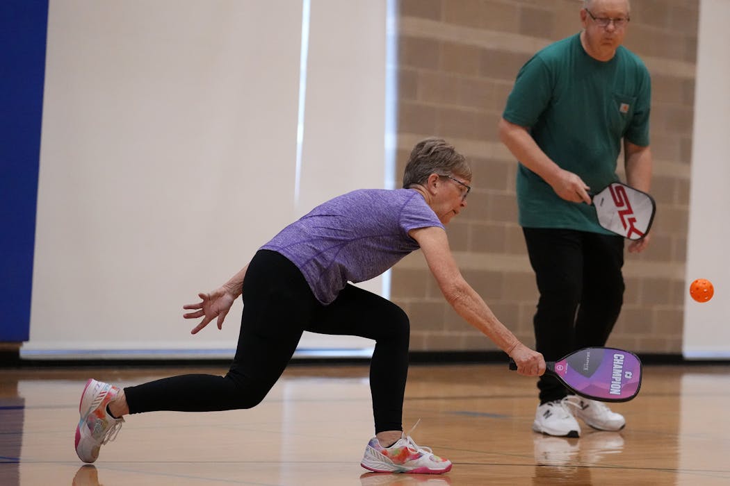 Mary Ann Goens-Bradley extends herself as she reaches for a ball during a friendly pickup game of pickleball Thursday, Nov. 3, 2022 at the Northeast Recreation Center in Minneapolis. ] ANTHONY SOUFFLE • anthony.souffle@startribune.com