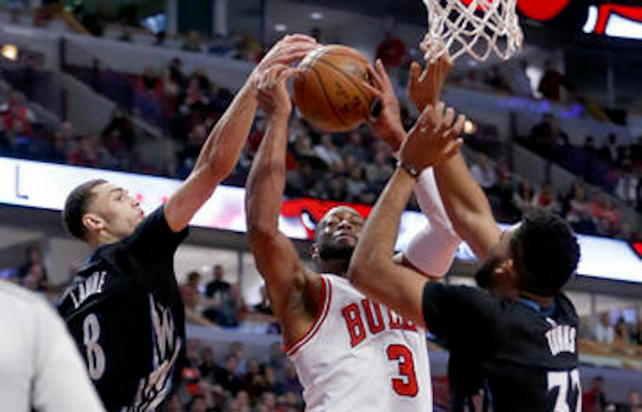 Zach LaVine, left, blocked a shot by Chicago's Dwyane Wade late in the second half Tuesday night in Chicago. Wade was held to 12 points, half of LaVine's scoring output.