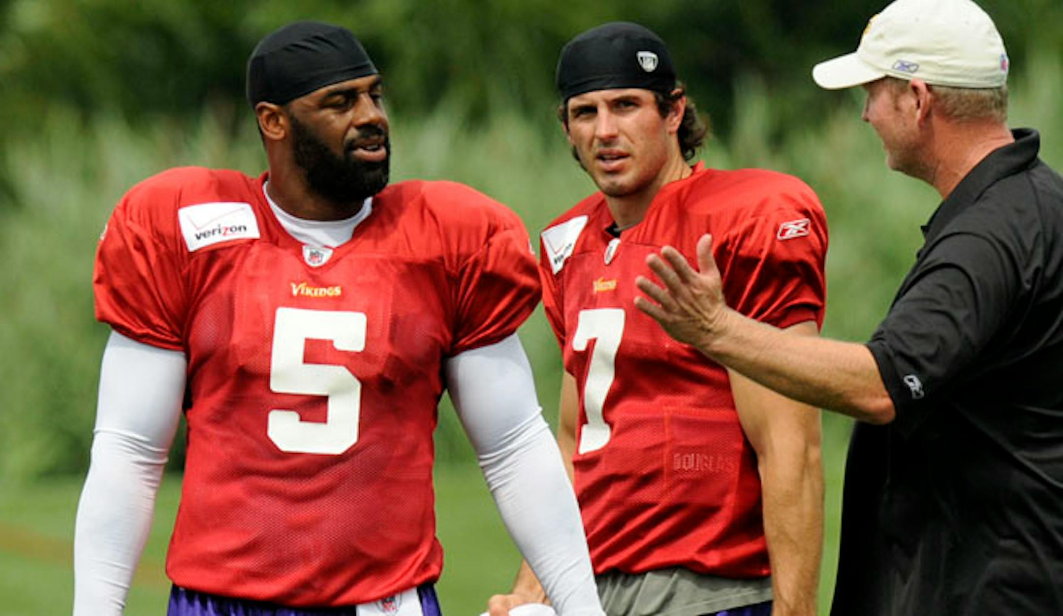 Minnesota Vikings quarterbacks Donovan McNabb and Christian Ponder listen to Bill Musgrave, vikings offensive cordinator