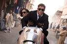 This image released by Sony Pictures shows Chris Hemsworth, foreground, and Tessa Thompson in a scene from Columbia Pictures' "Men in Black: Internati