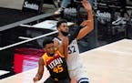 Utah Jazz guard Donovan Mitchell (45) and Minnesota Timberwolves center Karl-Anthony Towns (32) battle for position under the boards during the second
