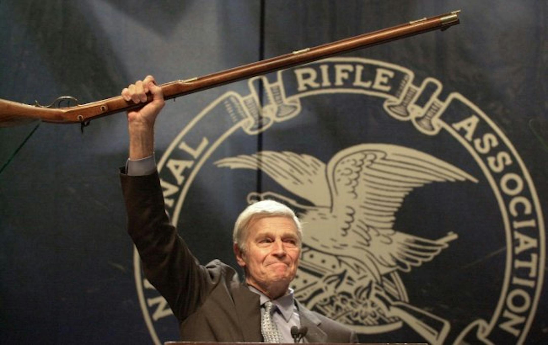 The late actor Charlton Heston, former president of the National Rifle Association, holds up a musket.