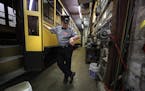 Volunteer John Reinan checked his watch at the start of the day as he waited inside the trolley storage and maintenance garage.