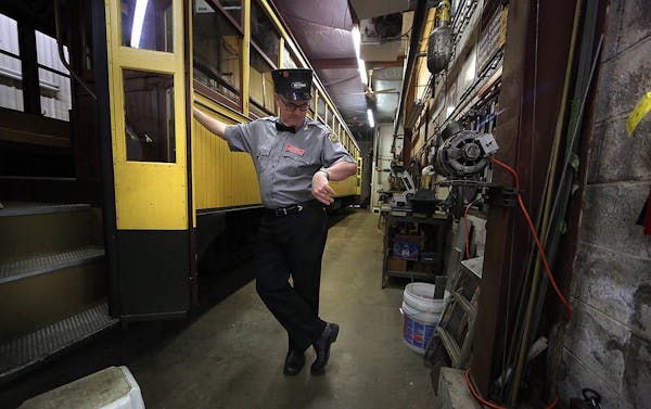 Volunteer John Reinan checked his watch at the start of the day as he waited inside the trolley storage and maintenance garage.