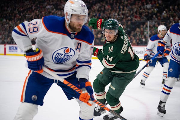 Joel Eriksson Ek (14), battling Edmonton’s Leon Draisaitl for a puck on Dec. 1, is one of only two Wild players who had career-best point totals las