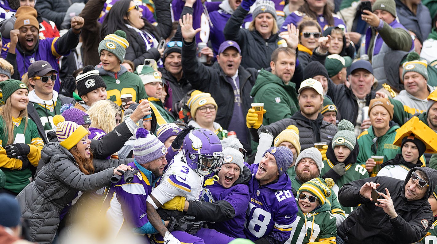 Vikings wide receiver Jordan Addison (3) jumps into the stands for a "Lambeau Leap" in the third quarter at Lambeau Field in Green Bay, Wis., on Sunday, Oct. 29, 2023. ] Elizabeth Flores • liz.flores@startribune.com