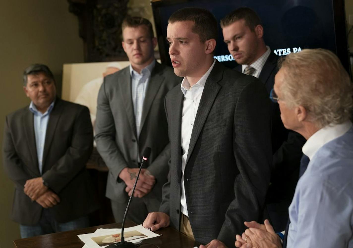 Ben Hoffman teared up as he spoke about why he and his brothers, behind him Luke Hoffman, left, and Stephen Hoffman, right, have gone public as their attorney Jeff Anderson right, sues the Vatican to release the names of priest accused of sexual abuse. The brothers are survivors of abuse from former priest Curtis Wehmeyer, who Archbishop Nienstedt failed to discipline even after other incidents. They spoke at a press conference with attorney Jeff Anderson in St. Paul, Minn., on Tuesday, May 14,