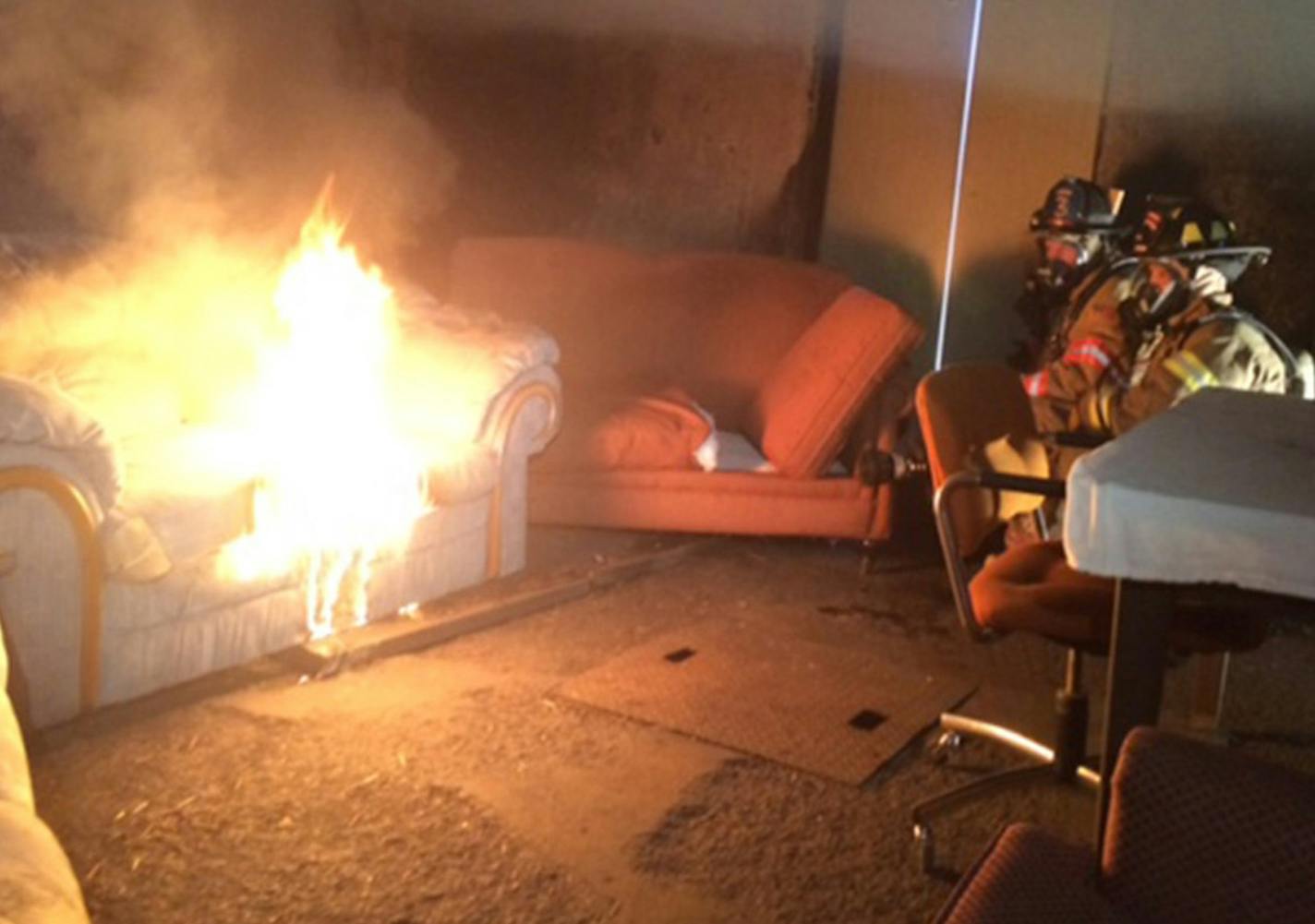 St. Paul fire fighters Chris Parsons, President of Minnesota Professional Fire Fighters, and Pete Gutzmann monitor a couch fire set at a training facility to demonstrate how flame retardants release dangerous chemicals. Firefighters want flame retardants phased out, but their effort has stalled in the Minnesota House. ] ABBY SIMONS/STAR TRIBUNE ORG XMIT: MIN1504301240292265