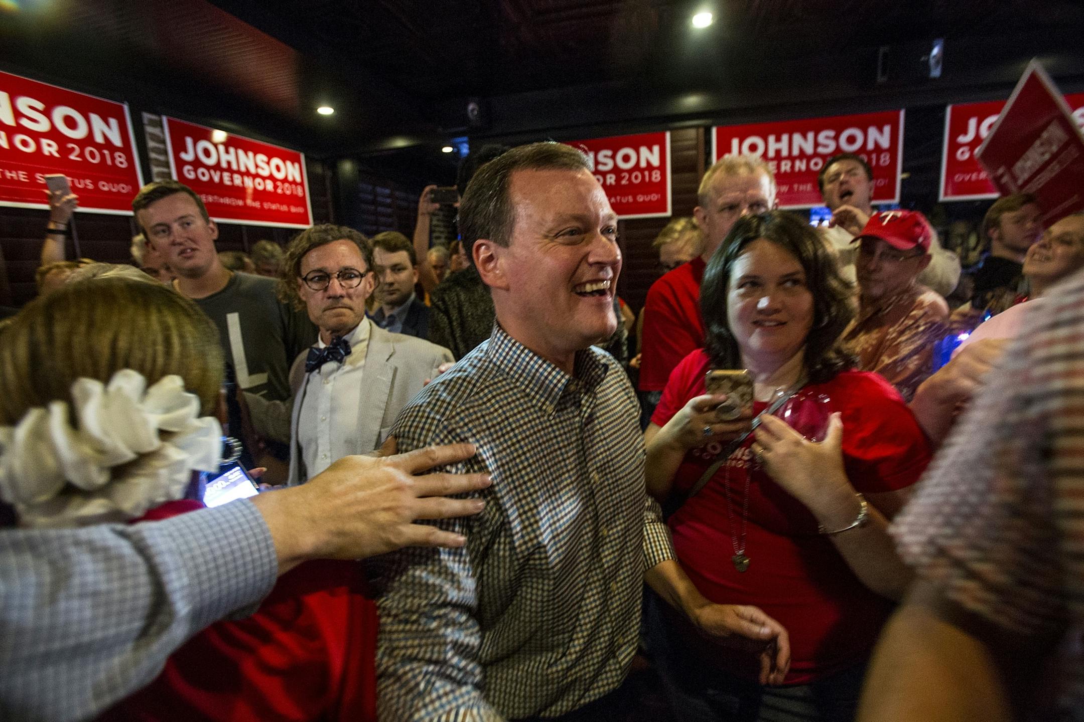 Jeff Johnson is greeted by his supporters after returning to the watch party, his victory all but official.