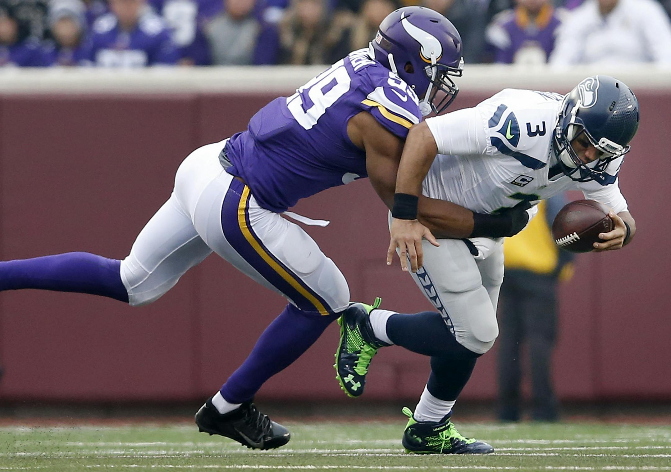 Danielle Hunter (99) sacked Seattle quarterback Russell Wilson (3) in the second quarter.