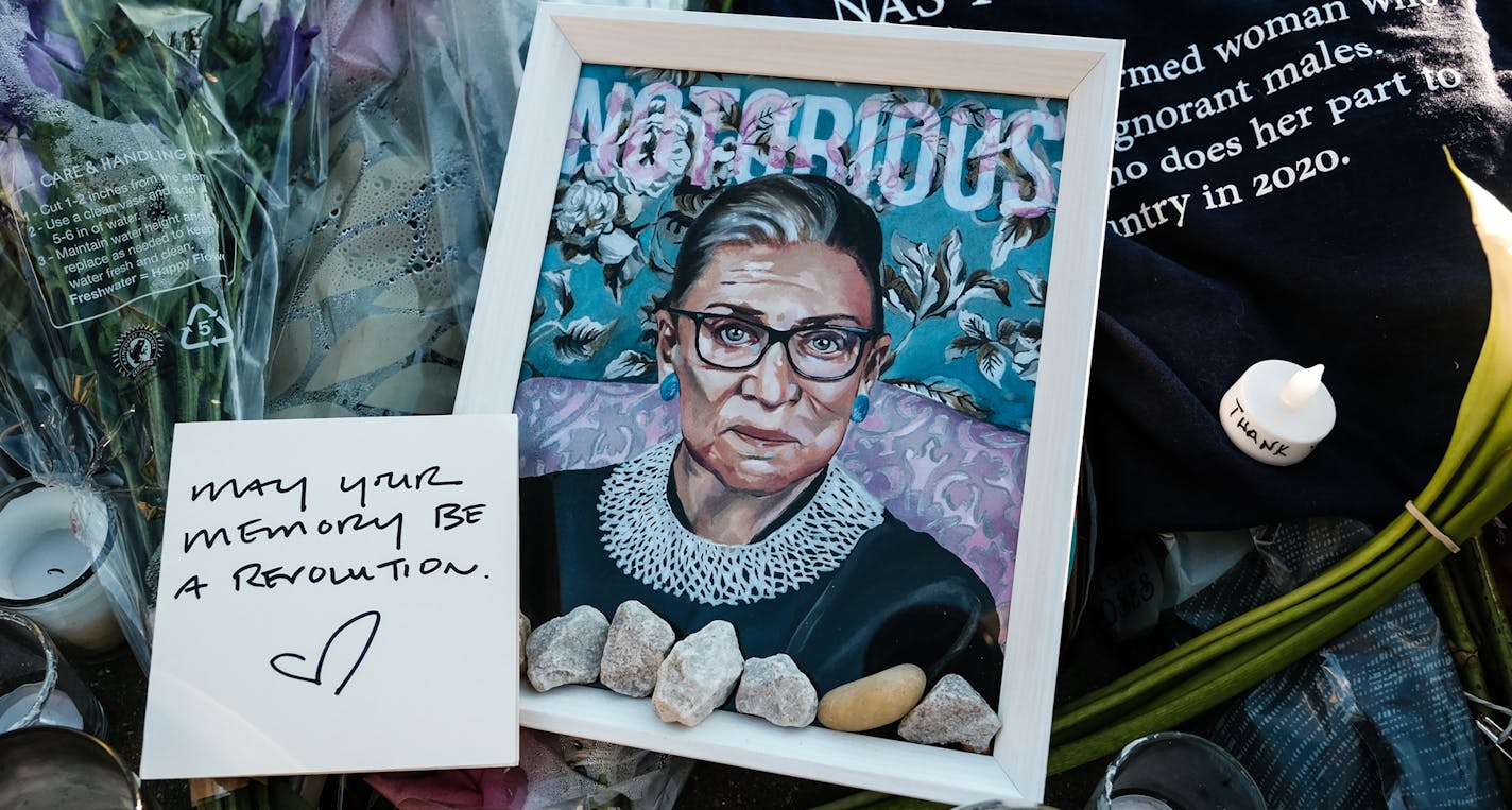 Signs and candles placed at a makeshift memorial outside the Supreme Court building in Washington, on Sunday, Sept. 20, 2020, following the death of Justice Ruth Bader Ginsburg. (Michael A. McCoy/The New York Times)