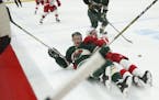 Minnesota Wild center Charlie Coyle (3) and Detroit Red Wings right wing Gustav Nyquist (14) found themselves on the ice after losing control of the p