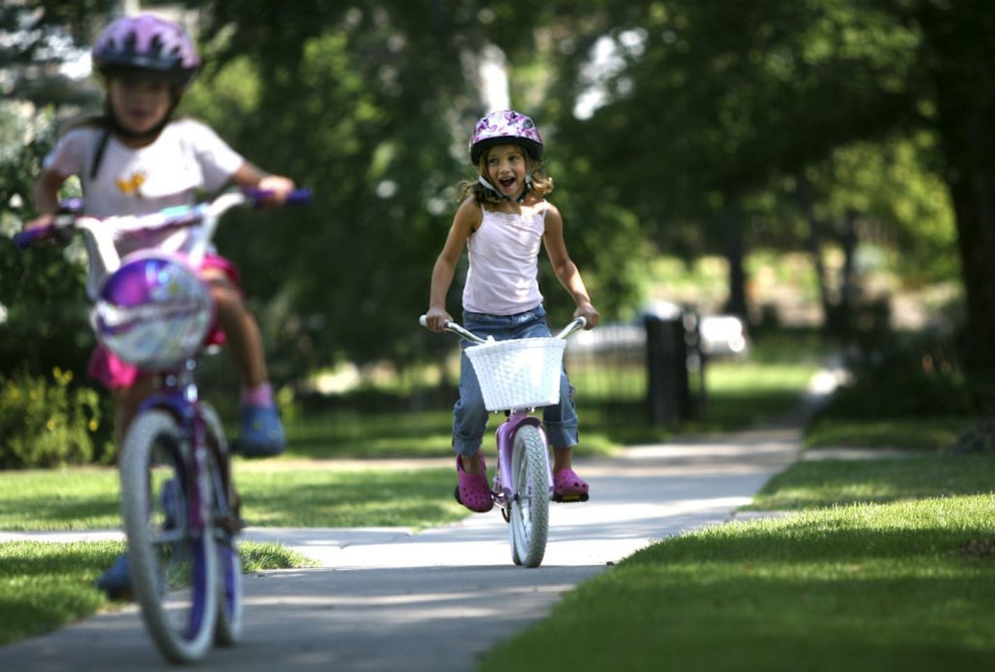 RENEE JONES SCHNEIDER � reneejones@startribune.com Edina, MN - August 17, 2007 - Kiki Hankinson (right) rode bikes with her neighbor Maggie Sexton up and down the sidewalk in front of their homes on Maple Road in Edina Friday morning. Before the sidewalk was put in on Maple Road there was a lot of opposition from the neighborhood. Kiki's mother Heather Hankinson moved to the neighborhood six months ago after the sidewalk was built. "Sidewalks were huge when we looked for a house, " said Hankinso