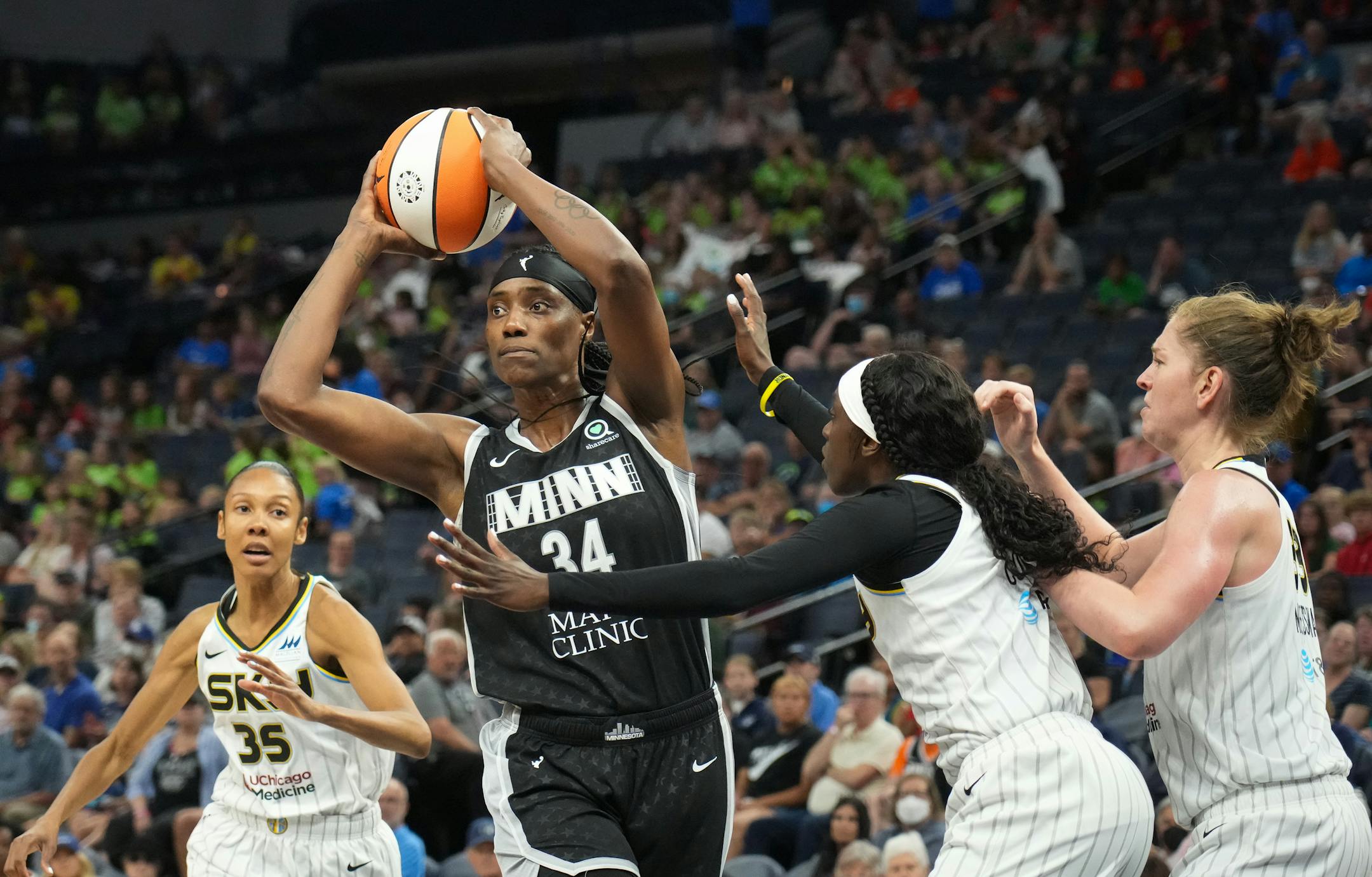 Minnesota Lynx center Sylvia Fowles (34) is double-teamed by Chicago Sky's Kahleah Copper (2) and Emma Meesseman (33) in the second half.