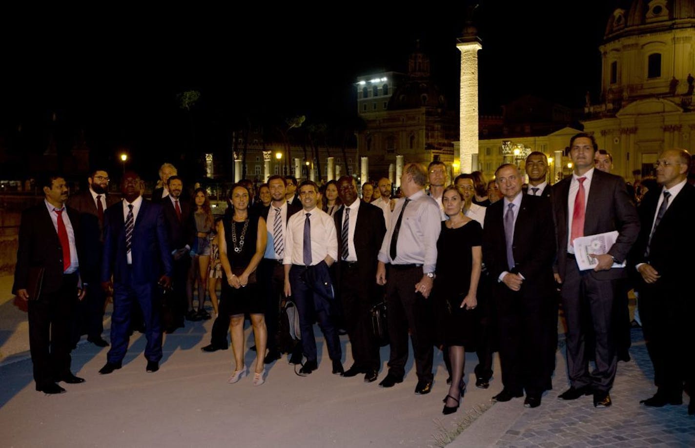 Rome's mayor Ignazio Marino, fourth from left, arrives with mayors from around the world to attend a performance in Rome's Foro di Augusto, Tuesday, July 21, 2015. Dozens of environmentally friendly mayors from around the world are meeting at the Vatican this week to bask in the star power of eco-Pope Francis and commit to reducing global warming and helping the urban poor deal with its effects.