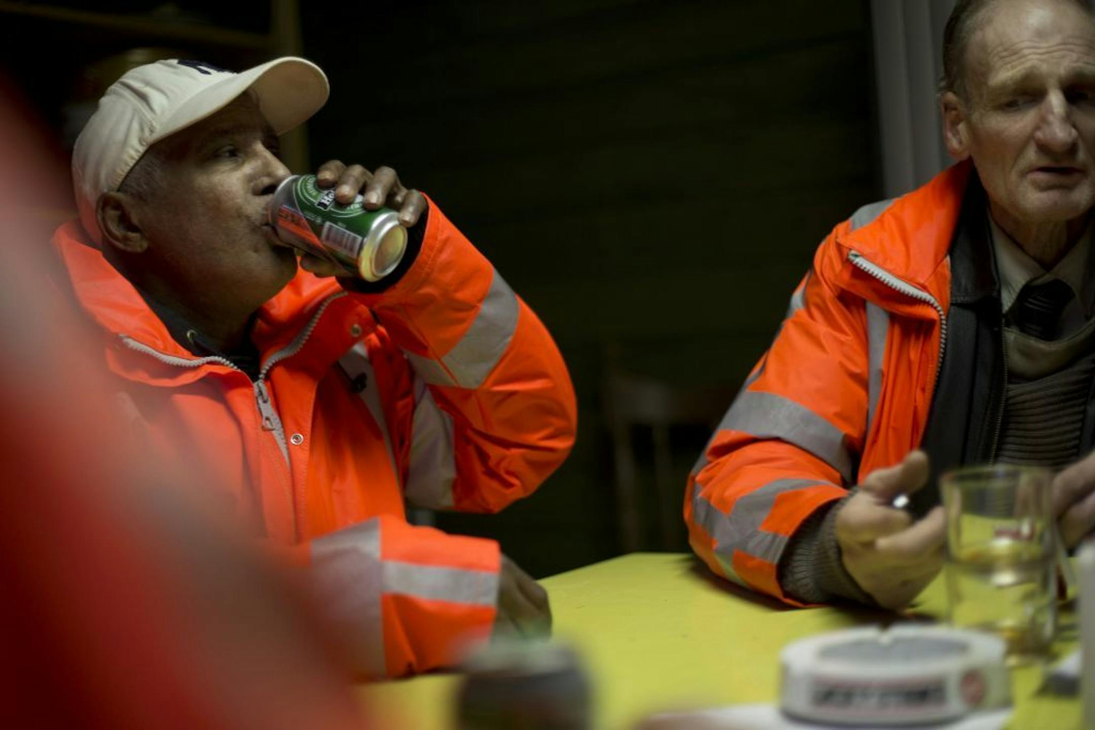 Ramon Mohamed Halim Smits, left, and Fred Schiphorst, participants in a pilot project for alcoholics, pause for a beer and cigarettes in their clubhouse in Amsterdam's eastern part Wednesday Jan. 15, 2014.
