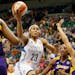 Maya Moore drove to the basket on Nneka Ogwumike, and Armintie Herrington of the Sparks during WNBA action between the Minnesota Lynx and Los Angeles 