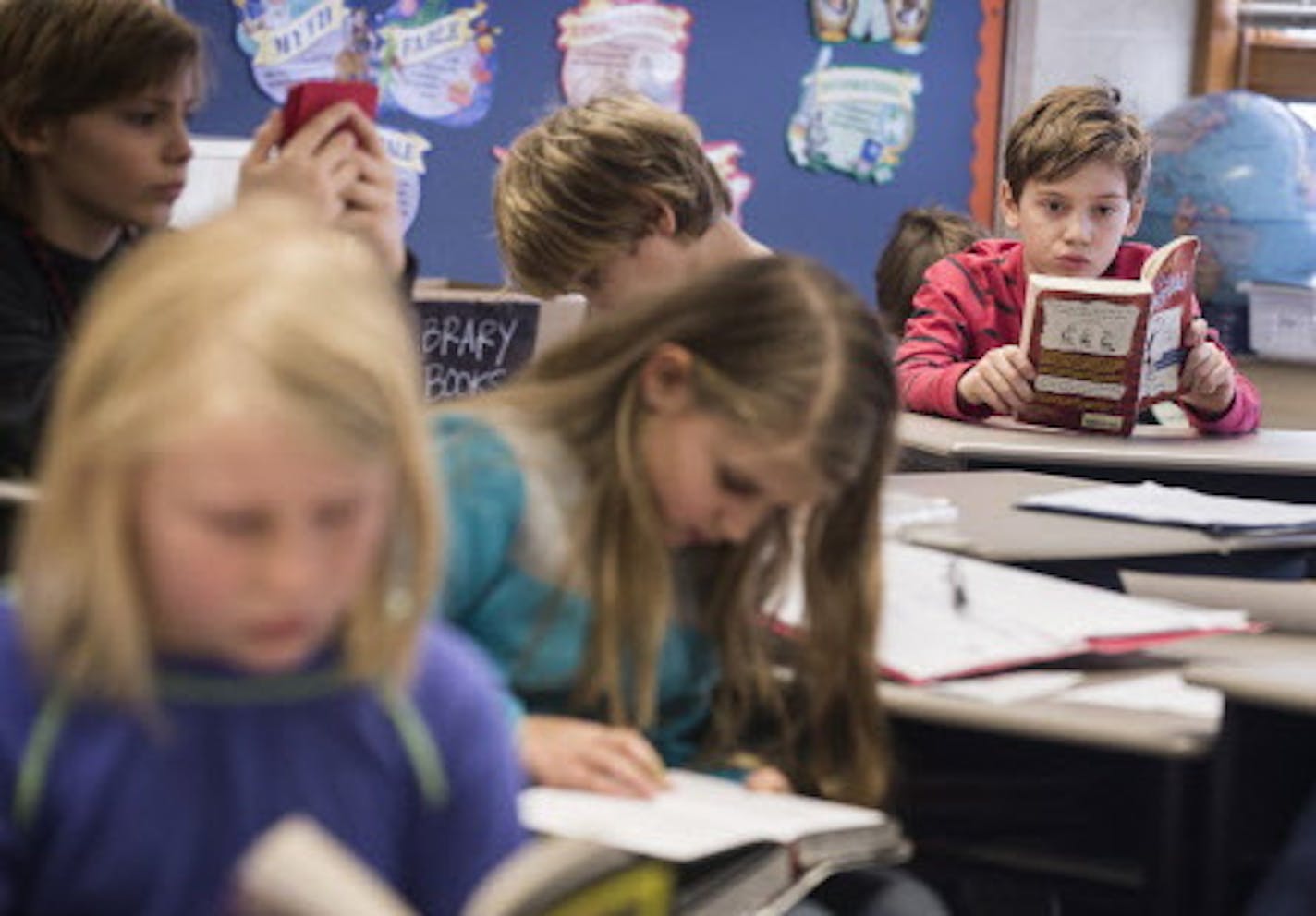 Students read last year at Marine Elementary in Marine on St. Croix, one of the sites the district decided to close. The others are in Hugo and Stillwater.