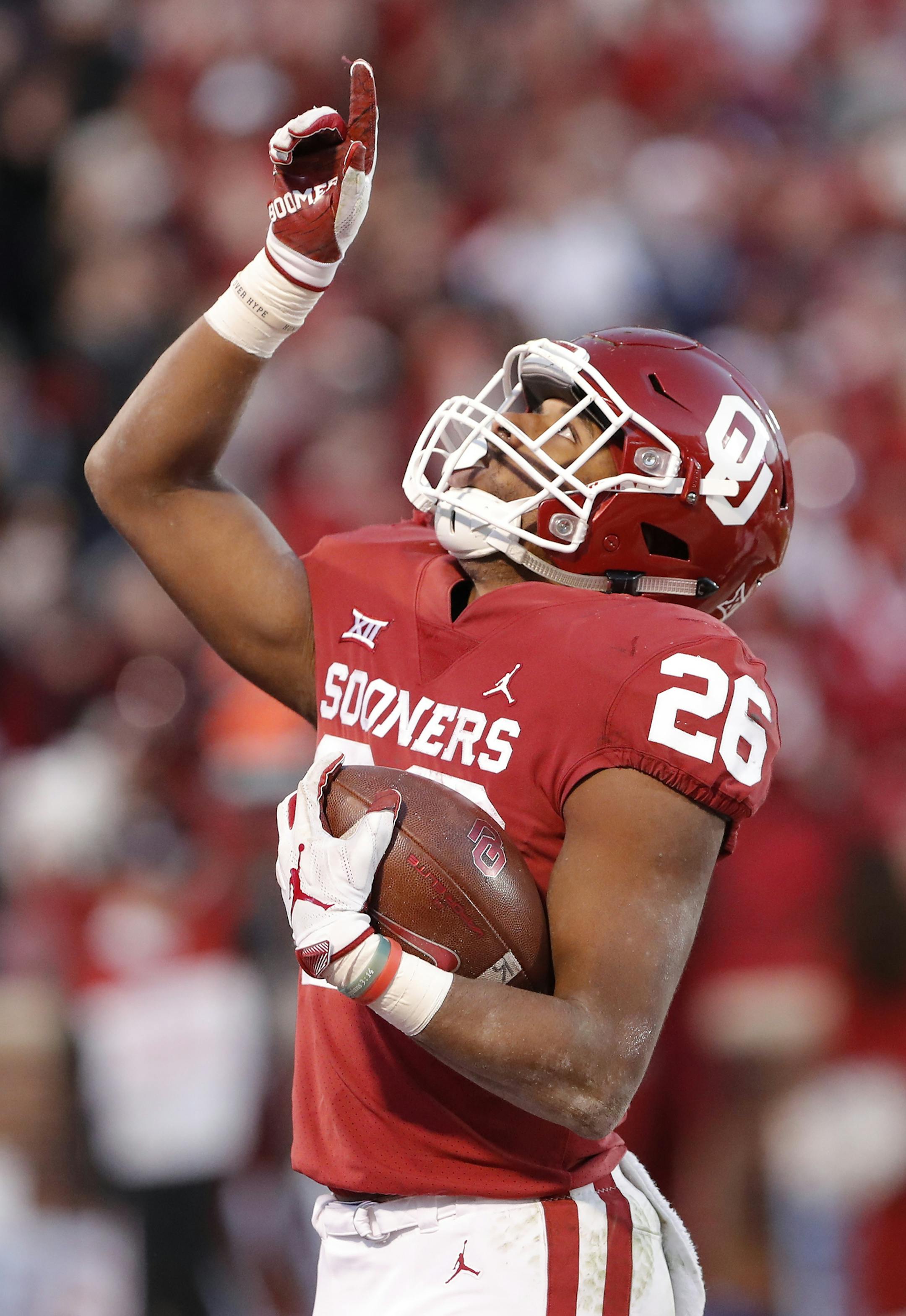 Oklahoma running back Kennedy Brooks (26) reacts after making a touchdown against Oklahoma State in the second half of an NCAA college football game in Norman, Okla., Saturday, Nov. 10, 2018. Oklahoma won 48-47. (AP Photo/Alonzo Adams)
