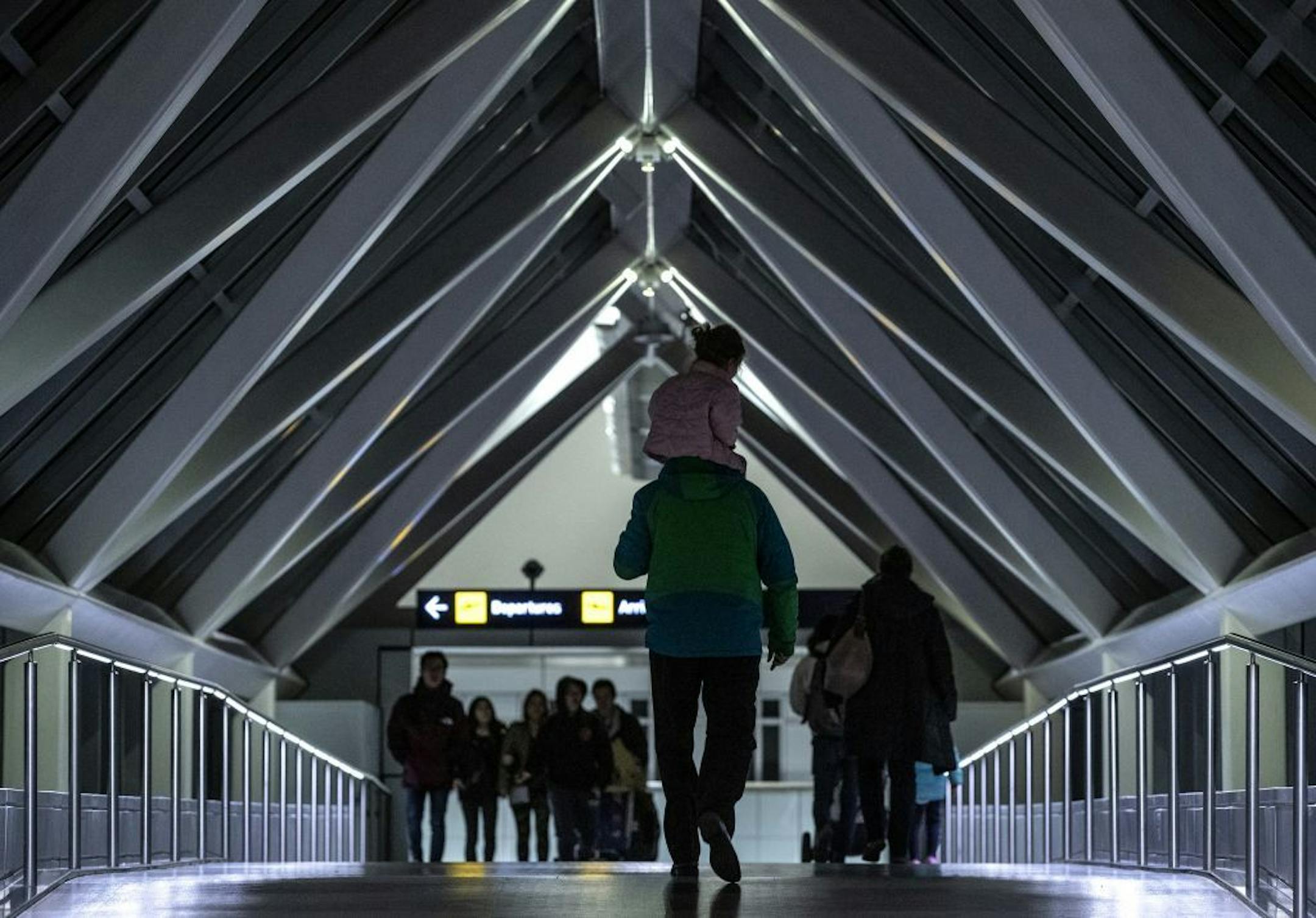 Pedestrians and travelers crossed the skyway from the terminal to the parking ramps at the Minneapolis-Saint Paul International Airport.