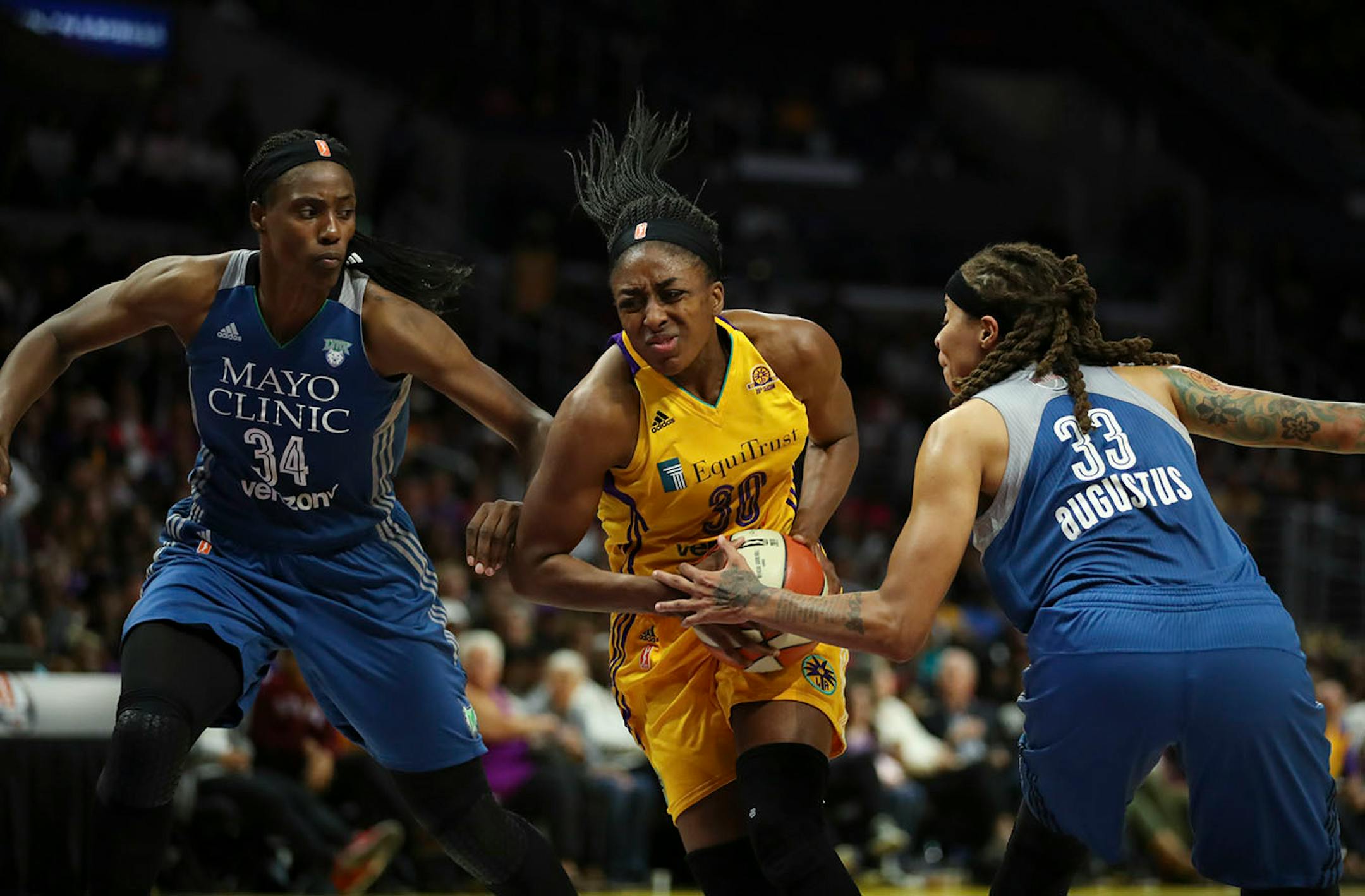 Minnesota Lynx center Sylvia Fowles (34) and guard Seimone Augustus (33) double covered Los Angeles Sparks forward Nneka Ogwumike (30) in the third quarter.