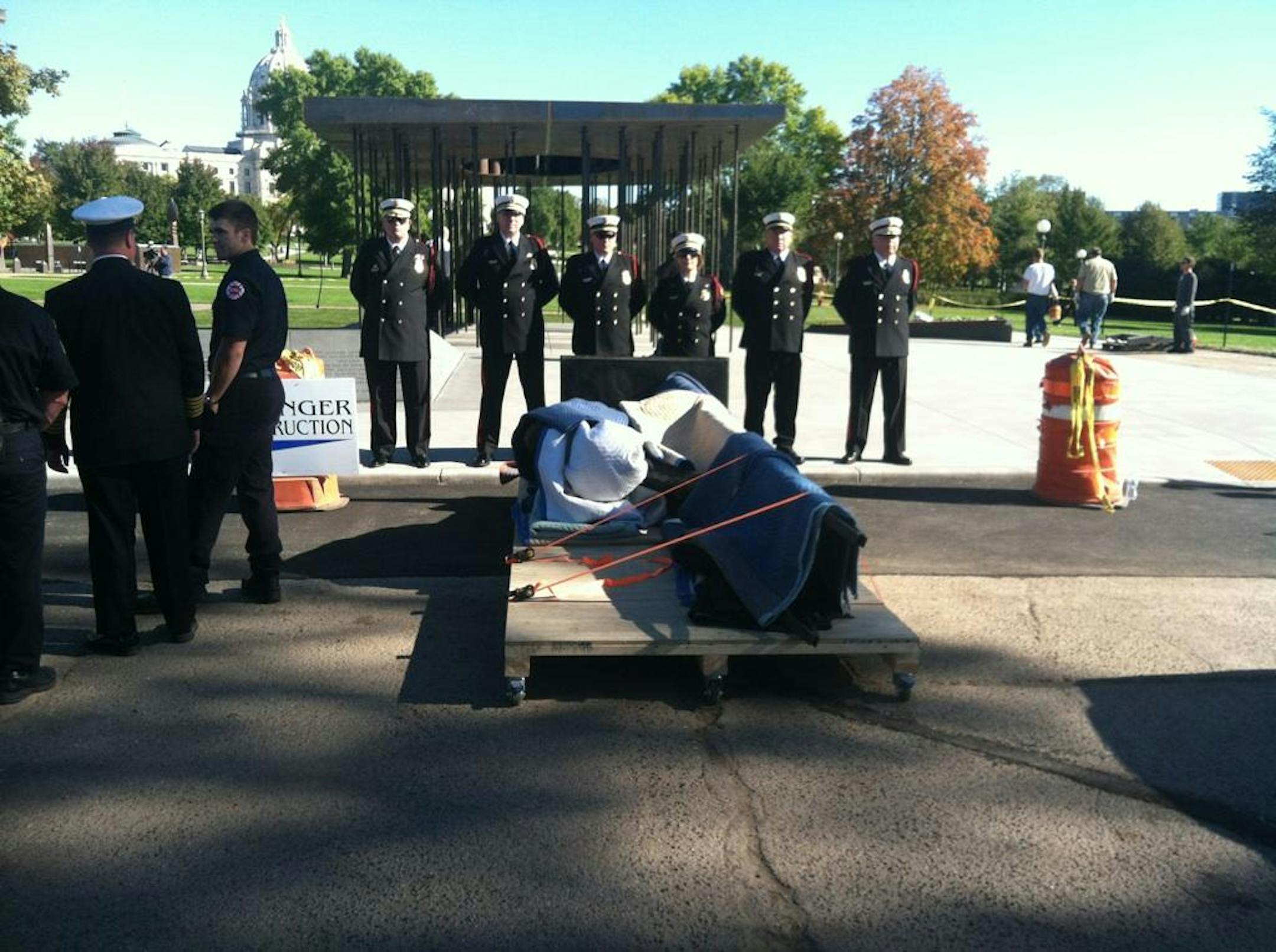 The Minnesota Fallen Firefighter sculpture, under cover until Tuesday afternoon and under the watch of an honor guard.