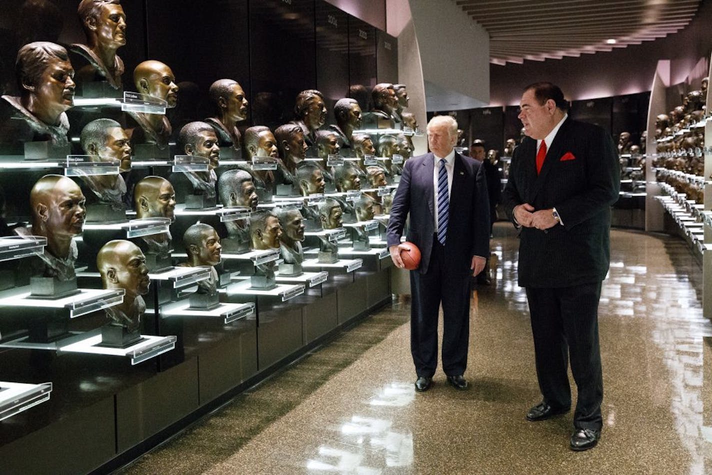 David Baker, the president of the Pro Football Hall of Fame, right, gives a tour to Republican presidential candidate Donald Trump, Wednesday, Sept. 14, 2016, in Canton, Ohio.