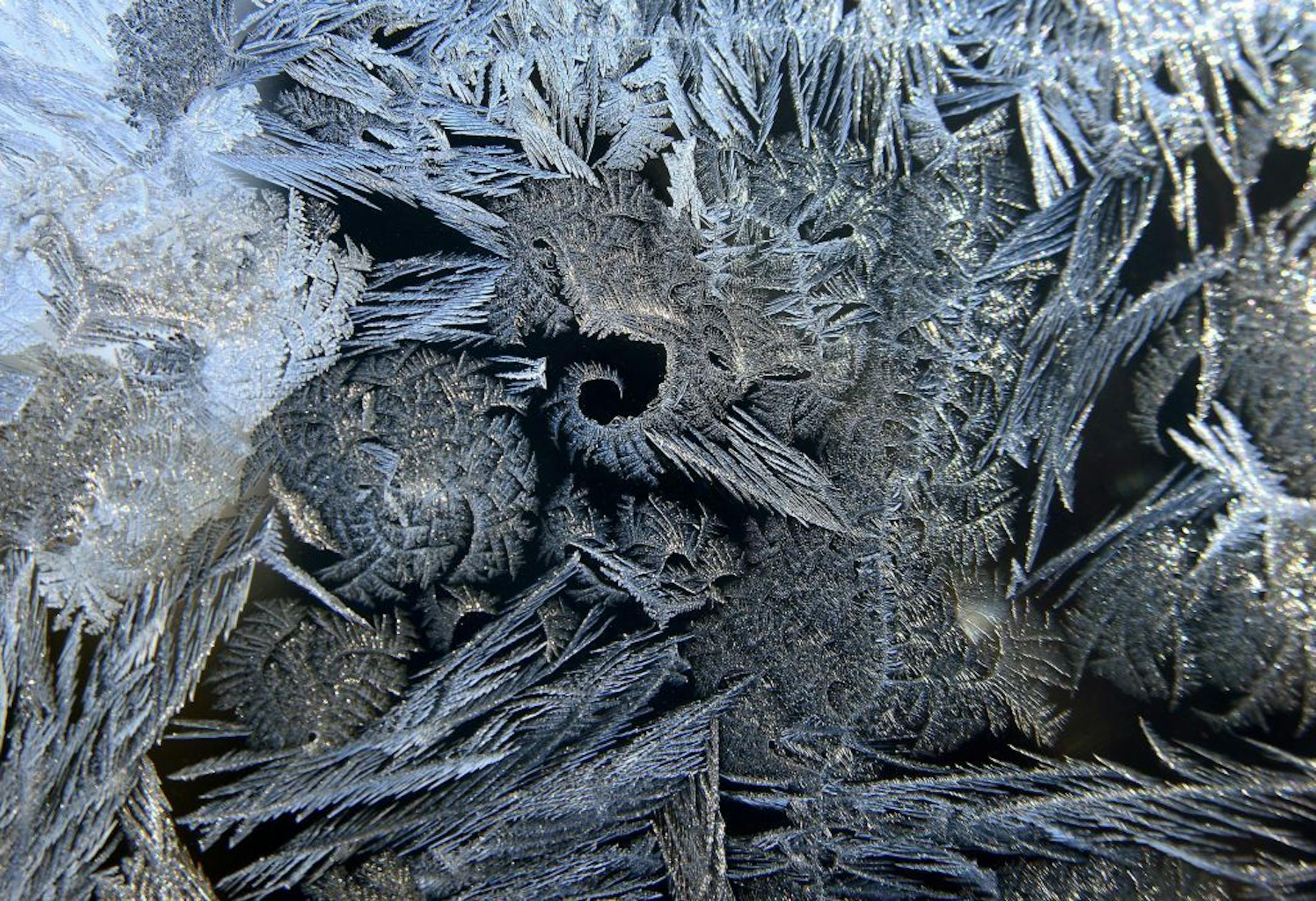 Ice crystals form frost on the window of a home in Medina, Minn., as the area experiences subzero temperatures on Monday, Jan. 21, 2013.