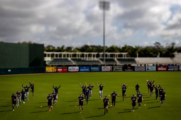 Minnesota Twins pitchers warmed up before practice on Friday in Fort Myers.