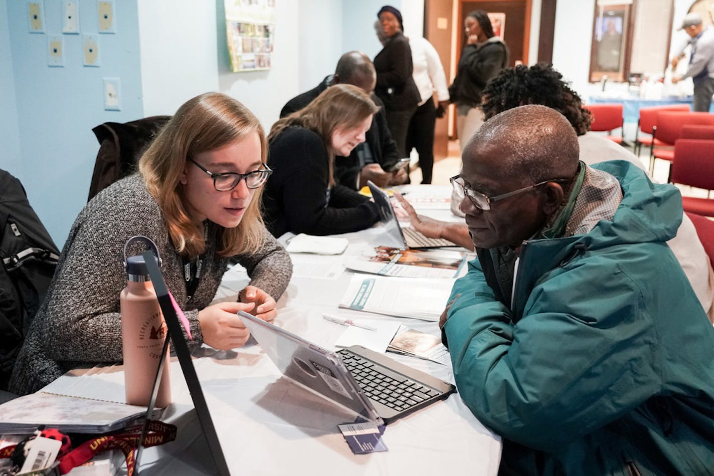 Kirkpatrick Weah, right, applied for a census job with help from recruiting assistant Lara Schueth. He wants to ease Liberian-Americans' anxiety about participating in the count.