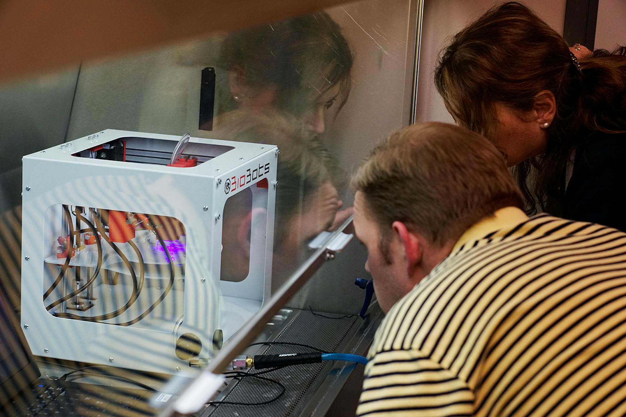 At the U of M, cardiology, Dr. Angela Mortari is using the school's first "bioprinter" to print with a 1/3 replica of a human nose with organic material. She works with science researcher Andy Price, left.